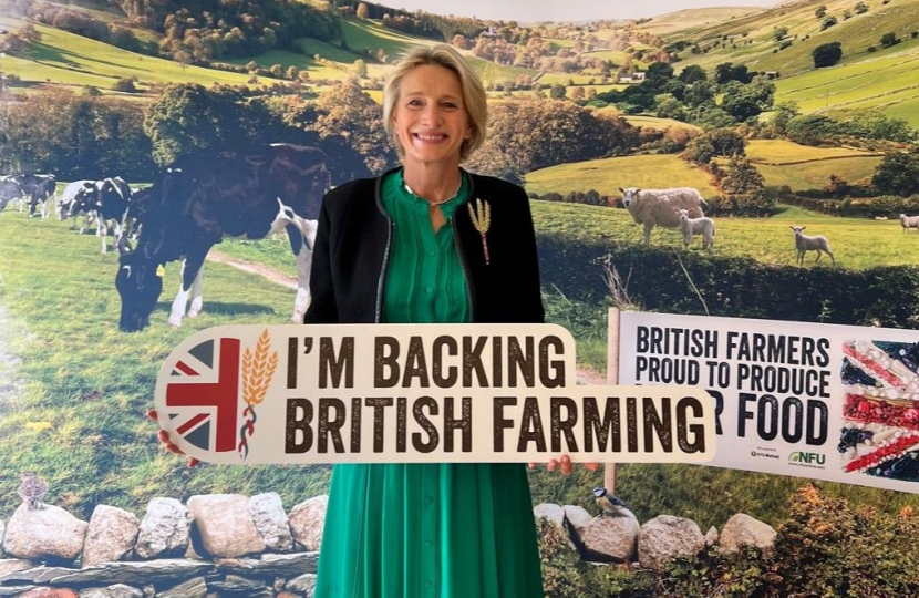 Alison Griffiths MP with a sign saying "Back British Farming"