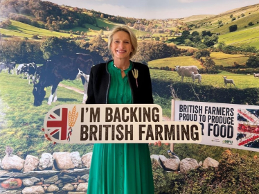 Alison Griffiths MP with a sign saying "Back British Farming"